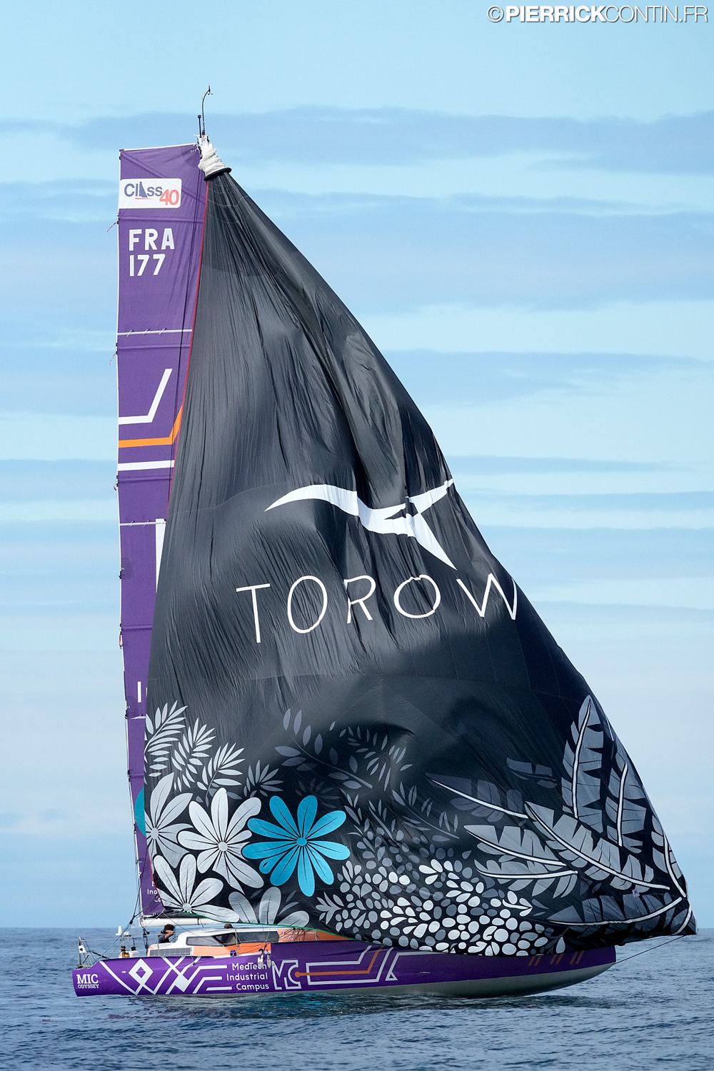 The Class40 DIATOMA SOLO SAILOR (FRA 177) under a black TOROW-branded spinnaker